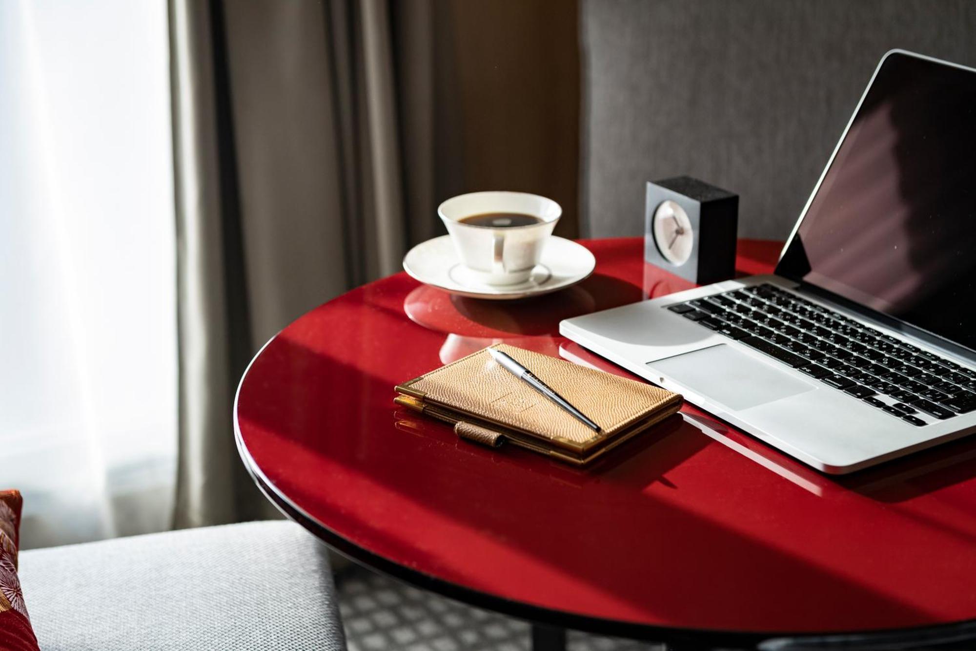 Kyoto Tokyu Hotel Exteriör bild A table with a laptop, a cup of coffee, a notebook and a pen